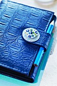 Personal organiser with fastener decorated with button