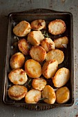 Roast potatoes with rosemary in a roasting tin