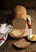 Rye bread, partly sliced, with butter