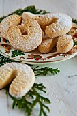 Vanillekipferl (cresent-shaped vanilla biscuits) on a Christmassy plate