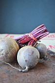 A bunch of raw beetroots on a rusted metal tray