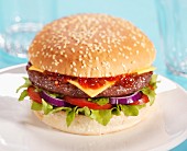 Cheeseburger with tomatoes, onions, lettuce and ketchup