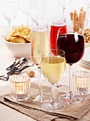 Assorted glasses of wine and sparkling wine, with party snacks