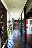 Balcony with sliding sunshade panels and long glass wall