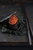 Maki sushi with salmon roe between sheets of salty nori (Japan)