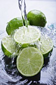 Limes in water with a jet of water