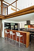 Open-plan kitchen with counter and barstools