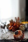 Festive table decoration with Christmas tree baubles and stag figurine