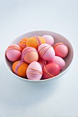 Bowl of dyed Easter eggs wrapped with yarn