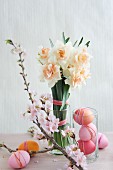 Easter arrangement of dyed eggs, narcissus & sprig of cherry blossom