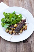 Venison skewers with watercress salad and chestnuts