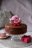 Chocolate cake decorated with raspberries and roses for Valentine's Day