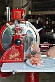 Parma ham being sliced by a machine