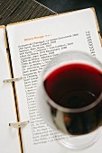 A glass of red wine on a wine list