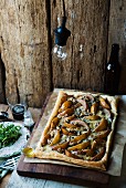 Puff pastry tart topped with pears, blue cheese, walnuts and rocket