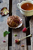 Raspberry and pistachio muffin with a cup of tea