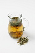 Coltsfoot infusion in a glass jug