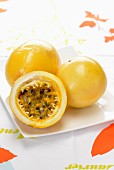 Yellow passion fruit, whole and cut in half