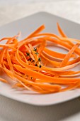 Carrot strips and thyme on a plate