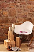 DIY box files upcycled from old wine crates and classic rocking chair by Eames against rustic stone wall