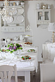 Set table in white dining room