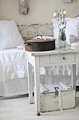 Old wooden crate and little old table in front of vintage-style couch