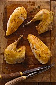 Roasted Chicken Pieces on a Wooden Cutting Board