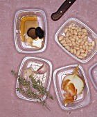 Plastic containers holding assorted ingredients for a savoury dish