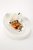 A cube of salmon, tuna in sesame seeds, courgette, pearl onion, peppers, a small serving of Pecorino soup, and chive cream