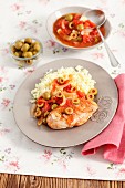 Chicken breast with green olives, onions, tomatoes and rice