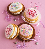Whoopie pies with icing and colorful sugar pearls