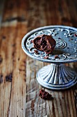 Dark chocolate muffin on an old fashion cake stand