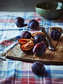 ripe plums on a wooden kitchen board