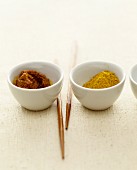 Curry paste and curry powder in small bowls