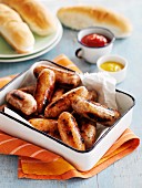 Roast sausages with condiments and bread