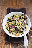 Rice with colourful lentils, almonds and red onions