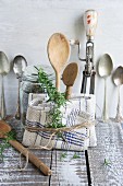 Old kitchen utensils: spoons, beater, wooden spoon and linen dish towel