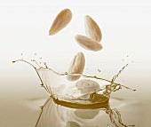 Almonds falling into oil