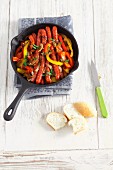 Mini sausages with peppers and onions