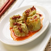 Four Edamame Shumai (Soy Bean Dumplings), on White Plate with Red Pepper Oil