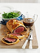 Beef Wellington with gravy and green beans