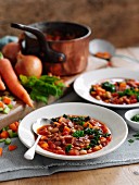 Bean soup with bacon, carrots and celery