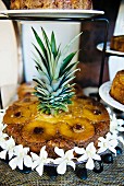 Celebration pineapple cake decorated with white flowers