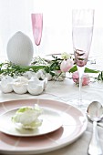 Easter place setting with egg-shaped candle and champagne flute