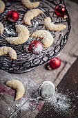 Vanilla crescents with Christmas baubles on a cake plate