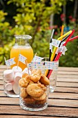 Baked treats, marshmallows and drinking straws decorated with flags for a child's birthday