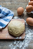 Fresh dough, eggs and a scattering of flour