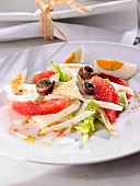 Vegetable salad with grapefruit, anchovies and egg