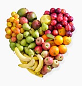 A fruit heart made of bananas, apples, pears, citrus fruits and plums