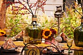 Outside dining table setting in autumnal color scheme.